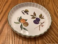 Top view of Royal Worcester Evesham Vale quiche pan showing fruit motif and fluted edge
