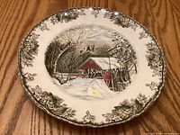 Front of Johnson Bros Friendly Village dinner plate showing Covered Bridge scene and border