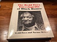 Front of hardcover book with dust jacket showing title, authors and Redd Foxx portrait