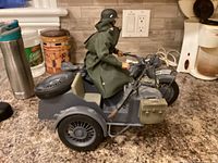 Side view of motorcycle with sidecar, soldier seated, visible accessories