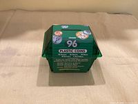 Front view of green plastic bank showing Coin-U-Lator label and denomination breakdown