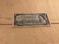 Front of 1967 $1 banknote showing portrait, denomination, serial number