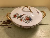 Covered bowl showing lid, gold handles, Bird of Paradise motif