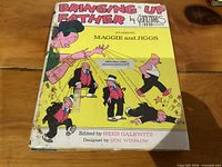 Front cover of hardcover book with title, authors, characters and wear