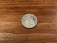 Reverse of 1969 Canadian 50-cent coin showing coat of arms