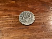 Reverse of 1978 Canadian Voyageur dollar coin showing canoe design