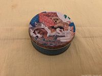 Round tin with cat and dog design lid, blue polka-dot sides