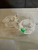 Top view of both cut glass pieces showing handles, spout and rim detail