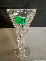 Front view of cut glass stem vase showing flared rim and etched pattern