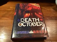 Front cover of Death in October hardcover book showing title, author, second printing note
