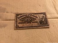 Front of 25-cent Dominion of Canada note showing seated allegorical figure and denomination