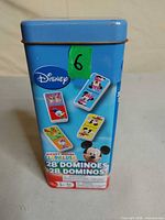 Front of blue Disney Mickey Mouse Clubhouse domino tin showing character domino artwork and 28 domino count