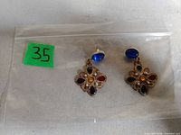 Front view of both earrings showing flower design and multicolored stones