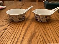 Pair of Figgjo Lotte gravy bowls, side view showing handles and decoration