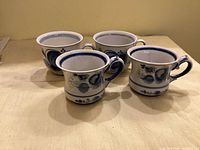 Four Gzhel porcelain coffee cups grouped to show pattern and quantity