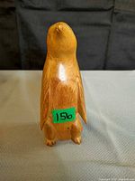 front view of carved wood penguin figurine