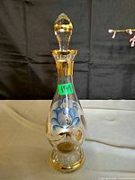 Full view of decanter with stopper showing overall shape and decoration