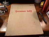 Front cover of beige hardcover book with red title