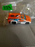Full view of orange Hot Wheels Rescue Duty truck in bag