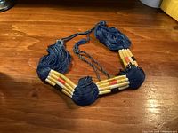 Full view of blue tasselled agal with bead sections