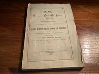 Front cover showing title, organization, event details, location, and print date