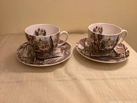 Two teacups with matching saucers, full set visible