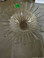 Top view of clear pressed glass bowl showing scalloped rim and radial pattern