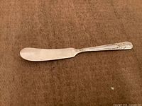 Top view of butter spreader showing blade and handle design