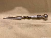 full view of letter opener showing blade and decorative handle