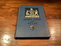 Front cover of blue hardcover book with illustration and title Mary, John and Peter