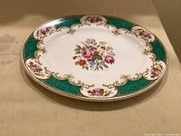 Top view of oval platter showing floral centre, green and gold border