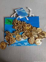 Full view of necklace with coin charms