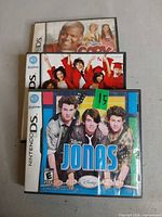 All three Disney Nintendo DS games stacked: Cory in the House, High School Musical 3, Jonas