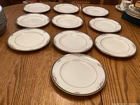 Ten matching Noritake Ontario salad plates arranged on table