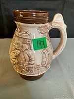 Full view of jug showing relief scene and handle