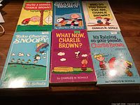 Front covers of the six Peanuts paperbacks