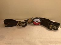 Front view of belt showing Poké Ball buckle and graphics