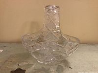 Cut crystal basket with pinwheel and diamond cuts on flat surface