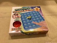 Front of sealed Push Pop Stress Buster box showing blue bubble mat