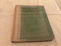 Front cover of green cloth hardcover showing title and author