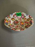 Top view of floral chintz oval bowl with gold rim