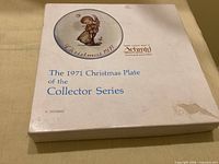 Front of presentation box showing branding and water stain