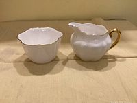 Front view of creamer and sugar bowl