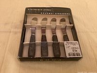 Front view of boxed set showing four spreaders and labeling