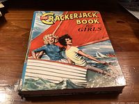 Front cover of The Crackerjack Book for Girls showing artwork and spine wear