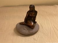 Front view of bronze-tone Little Mermaid figurine on stone base
