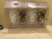 Front view of sealed box containing four Torre & Tagus dragon pattern glasses