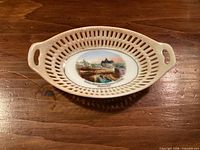 Top view of oval reticulated ceramic souvenir dish with Ottawa landmark image