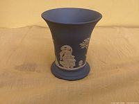 Full view of vase showing blue body and white relief detail