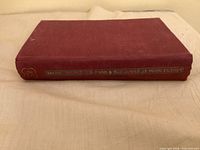 Book lying on side showing spine text 'Milne Winnie-the-Pooh & The House at Pooh Corner'